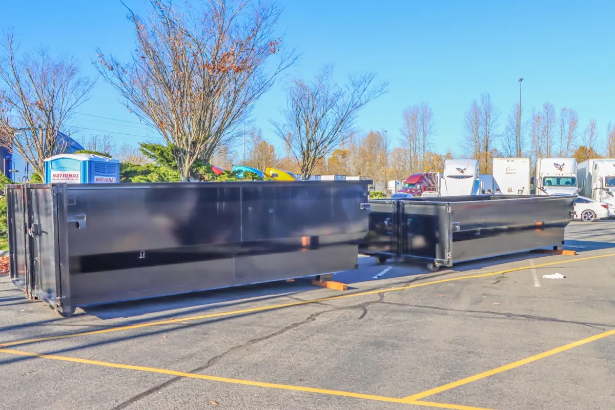 Professional dumpster rental service with roll-off container on residential driveway in Hobe Sound